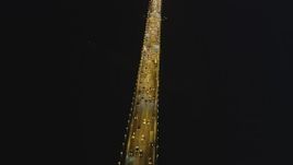 5K aerial stock footage tilt from bird's eye of traffic to fly over the Bay Bridge, San Francisco, California, night Aerial Stock Footage | DFKSF14_081