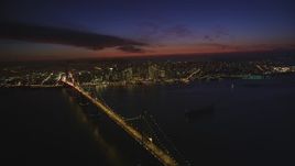 5K aerial stock footage of downtown skyscrapers seen while hovering over Bay Bridge, Downtown San Francisco, California, night Aerial Stock Footage | DFKSF14_083
