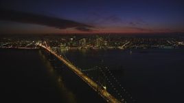 5K aerial stock footage descend near Bay Bridge, with views of skyscrapers in Downtown San Francisco, California, night Aerial Stock Footage | DFKSF14_084