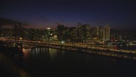 5K aerial stock footage of passing by Bay Bridge, with views of Downtown San Francisco skyscrapers, California, night Aerial Stock Footage | DFKSF14_087