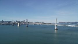 5K aerial stock footage of approaching the Bay Bridge, with views of Downtown San Francisco behind it, California Aerial Stock Footage | DFKSF15_004