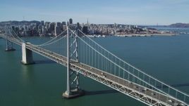 5K aerial stock footage of flying over the Bay Bridge and panning to Downtown San Francisco skyline, California Aerial Stock Footage | DFKSF15_007