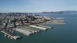 5K aerial stock footage flyby Coit Tower and North Beach piers, view of Golden Gate Bridge, San Francisco, California Aerial Stock Footage | DFKSF15_014