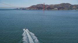 5K aerial stock footage of approaching boat on the bay, tilt to reveal Golden Gate Bridge, San Francisco, California Aerial Stock Footage | DFKSF15_022