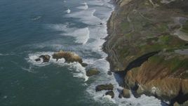5K aerial stock footage fly away from waves rolling into coastal cliffs and rock formations, Daly City, California Aerial Stock Footage | DFKSF15_050