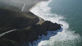 5K aerial stock footage of flying over Highway 1 traffic winding above coastal cliffs, Montara, California Aerial Stock Footage | DFKSF15_061