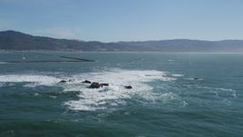 5K aerial stock footage of flying by rock formations near a harbor in Half Moon Bay, California Aerial Stock Footage | DFKSF15_069