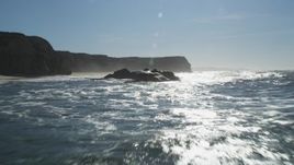 5K aerial stock footage of flying low over rock formation near cliffs, Half Moon Bay, California Aerial Stock Footage | DFKSF15_083