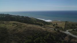 5K aerial stock footage of flying over hills and a road on the coast, San Gregorio, California Aerial Stock Footage | DFKSF15_085