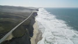 5K aerial stock footage of tilting from the coastal beach revealing Highway 1, San Gregorio, California Aerial Stock Footage | DFKSF15_090