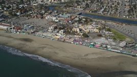 5K aerial stock footage of tilting from the ocean to reveal roller coaster at Santa Cruz Beach Boardwalk, California Aerial Stock Footage | DFKSF15_131