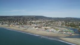 5K aerial stock footage of flying away from Santa Cruz Beach Boardwalk and coast, Santa Cruz, California Aerial Stock Footage | DFKSF15_138