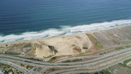 5K aerial stock footage fly away from Fort Ord Dunes State Park, reveal Highway 1 coastal road, Moss Landing, California Aerial Stock Footage | DFKSF15_152