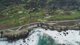 5K aerial stock footage of 17 Mile Drive coastal road and golf course near homes in Pebble Beach, California Aerial Stock Footage | DFKSF16_017