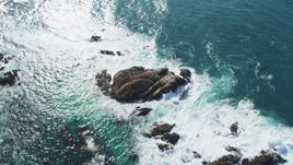 5K aerial stock footage tilt from waves crashing into rock formations to reveal Cypress Point Golf Course, Pebble Beach, California Aerial Stock Footage | DFKSF16_019
