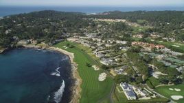 5K aerial stock footage of passing by an oceanfront resort hotel and golf course in Pebble Beach, California Aerial Stock Footage | DFKSF16_029