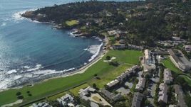 5K aerial stock footage of a resort hotel and golf course on the shore of Carmel Bay in Pebble Beach, California Aerial Stock Footage | DFKSF16_031