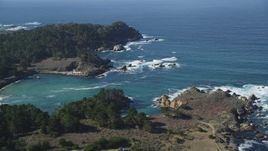 5K aerial stock footage of tilting from a coastal highway to reveal Whalers Cove, Carmel, California Aerial Stock Footage | DFKSF16_043