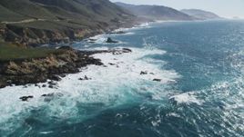 5K aerial stock footage of flying over kelp near waves crashing against coastal cliffs, Carmel, California Aerial Stock Footage | DFKSF16_056