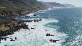 5K aerial stock footage of flying over the waves rolling toward the coastal cliffs, Carmel, California Aerial Stock Footage | DFKSF16_057