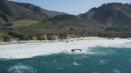 5K aerial stock footage of flying by waves crashing on small beach, Carmel, California Aerial Stock Footage | DFKSF16_062