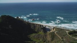 5K aerial stock footage of passing by the Rocky Creek Bridge above coastal cliffs, Carmel, California Aerial Stock Footage | DFKSF16_070