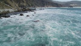 5K aerial \video of flying over the ocean, tilt up to reveal coastal cliffs, Big Sur, California Aerial Stock Footage | DFKSF16_080