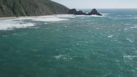 5K aerial stock footage of tilting up from the ocean to reveal coastal cliffs and rock formations, Big Sur, California Aerial Stock Footage | DFKSF16_100
