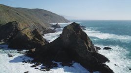 5K aerial stock footage tilt from the ocean to reveal coastal rock formations and cliffs, Big Sur, California Aerial Stock Footage | DFKSF16_101
