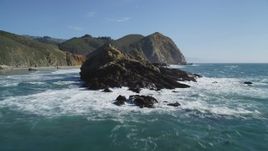 5K aerial stock footage tilt from the ocean to reveal rock formations near coastal cliffs, Big Sur, California Aerial Stock Footage | DFKSF16_104