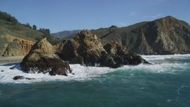 5K aerial stock footage of passing a rock formation near coastal cliffs, Big Sur, California Aerial Stock Footage | DFKSF16_105