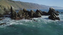 5K aerial stock footage tilt from ocean to reveal rock formation near coastal cliffs, Big Sur, California Aerial Stock Footage | DFKSF16_106