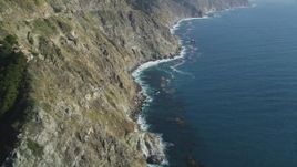 5K aerial stock footage of flying over rocky beach, tilting up along coastal cliffs, Big Sur, California Aerial Stock Footage | DFKSF16_113