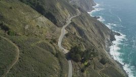 5K aerial stock footage of flying over the Highway 1 road atop coastal cliffs, tilt to cars, Big Sur, California Aerial Stock Footage | DFKSF16_116