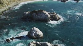 5K aerial stock footage of flying over large coastal rock formations in the ocean, Big Sur, California Aerial Stock Footage | DFKSF16_121