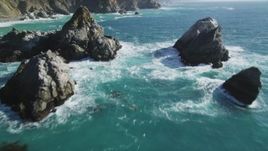 5K aerial stock footage of flying between large rock formations, tilt revealing coastal cliffs, Big Sur, California Aerial Stock Footage | DFKSF16_122