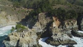 5K aerial stock footage of tilting from the ocean to reveal McWay Falls, Big Sur, California Aerial Stock Footage | DFKSF16_123