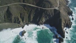 5K aerial stock footage of flying by small beach, pan right to Highway 1 atop coastal cliffs, Big Sur, California Aerial Stock Footage | DFKSF16_129