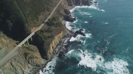 5K aerial stock footage of flying by a small bridge and Highway 1 atop coastal cliffs, Big Sur, California Aerial Stock Footage | DFKSF16_130