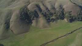 5K aerial stock footage of a reverse view of following green hills in San Luis Obispo County, California Aerial Stock Footage | DFKSF16_143
