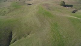 5K aerial stock footage of flying away from grassy hills in San Luis Obispo County, California Aerial Stock Footage | DFKSF16_145
