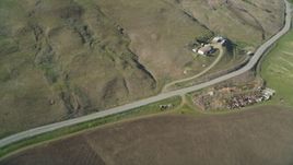 5K aerial stock footage fly away from farmhouse, country road, hills, and farm fields in San Luis Obispo County, California Aerial Stock Footage | DFKSF16_151