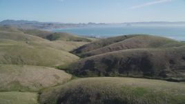 5K aerial stock footage of flying over hills, revealing the coastline in Cayucos, California Aerial Stock Footage | DFKSF16_152