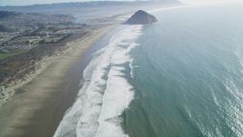 5K aerial stock footage of tilting from Morrow Strand Beach revealing Morro Rock, Morro Bay, California Aerial Stock Footage | DFKSF16_153