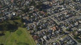 5K aerial stock footage of a reverse view of suburban homes, reveal Morro Bay Golf Course, California Aerial Stock Footage | DFKSF16_158