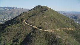 5K aerial stock footage tilt up slope of a mountain with dirt roads in San Luis Obispo, California Aerial Stock Footage | DFKSF16_159