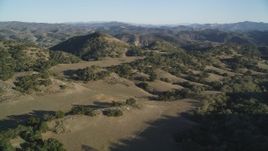 5K aerial stock footage of approaching hills and scattered trees in San Luis Obispo County, California Aerial Stock Footage | DFKSF17_007