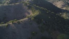 5K aerial stock footage of flying away from brown hills and trees in San Luis Obispo County, California Aerial Stock Footage | DFKSF17_010