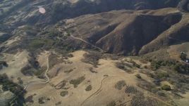 5K aerial stock footage of flying away from country roads in the hills, San Luis Obispo County, California Aerial Stock Footage | DFKSF17_012