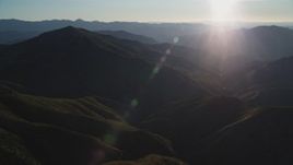 5K aerial stock footage flyby mountains with sun in the distance, San Luis Obispo County, California Aerial Stock Footage | DFKSF17_015